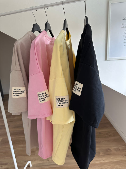 T Shirt LIFE ISN´T PERFECT BUT YOUR OUTFIT CAN BE. Gelb